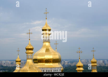 Orthodox Christian monastery. Golden domes of medieval cathedral and churches in Kiev-Pechersk Lavra Monastery, blue sky with clouds. Historic cultura Stock Photo