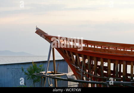Construction of a ship in Ierissos, Greece. Little shipyard of wooden ships. Stock Photo