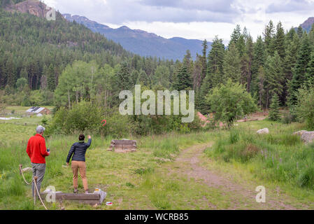 Couple playing horseshoes at the Minam River Lodge in Oregon's Wallowa Mountains. Stock Photo