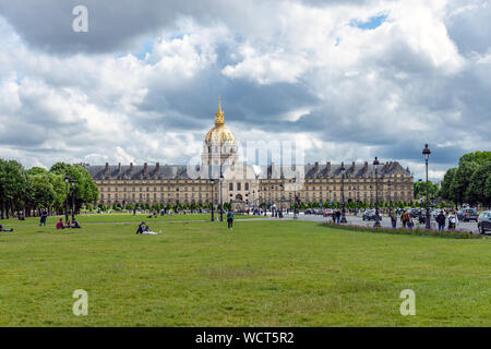 People walking and resting on avenue des Invalides Grass - Paris Stock Photo