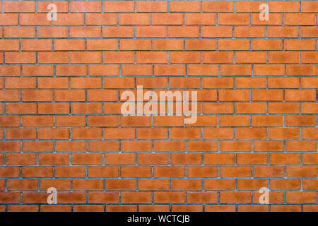 Wall texture from red brick horizontal masonry. Background from many bricks. Building material with a beautiful branchy pattern of surface. Decorative Stock Photo