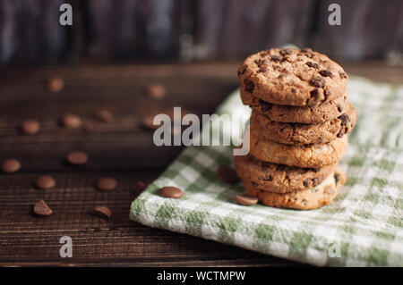 Oatmeal liver lies near the napkin in the box. Rustic table. Vintage toning. Dietary useful cookies without gluten. Copy space. Stock Photo