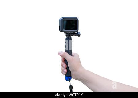 Isolated action camera on stich in hand. Blank screen for mockup. Stock Photo