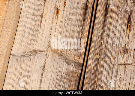 Wooden panels and boards of a rural house, Italy. Walls and ornaments in painted wood for the country house, ruined by time. Stock Photo