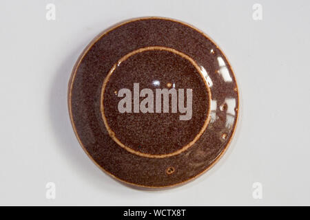 round clay probe with brown glossy glaze Stock Photo