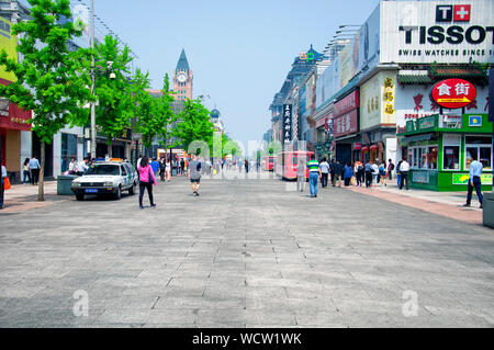 Beijing, China.  April 24, 2016.  People visiting the popular Wangfujing street within city of Beijing china on a hazy sunny day. Stock Photo