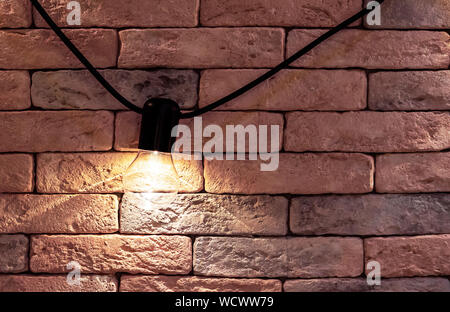 Electric lamp on a brick wall background. Loft style interior. Stock Photo