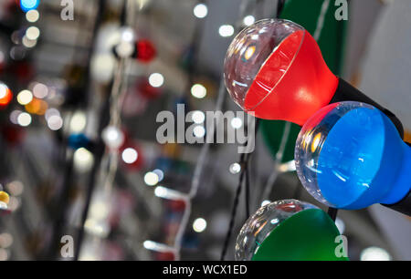 Garland with multi-colored lamps on the background of a beautiful bokeh. Stock Photo