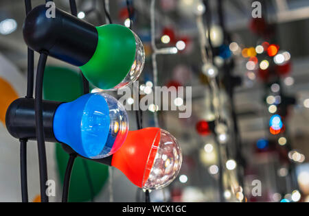 Garland with multi-colored lamps on the background of a beautiful bokeh. Stock Photo