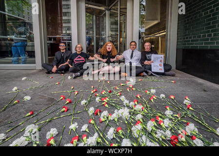 New York, USA. 28th Aug, 2019. Protesters dropped flowers by the people risking arrest symbolizing the many lives lost to overdose at a protest on August 28, 2019 at Governor Andrew Cuomo's NYC office to call on the Governor's inaction to enact the evidence-based overdose prevention policies that could save the lives of thousands of New Yorkers. Credit: Erik McGregor/ZUMA Wire/Alamy Live News Stock Photo