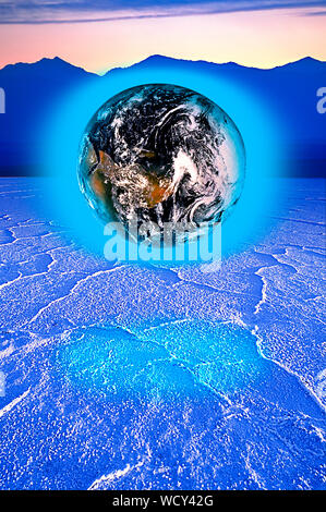 Futuristic view of a blue glowing earth floating over cracked blue salt flats. 'Eaarth element in this image furnished by NASA' Stock Photo