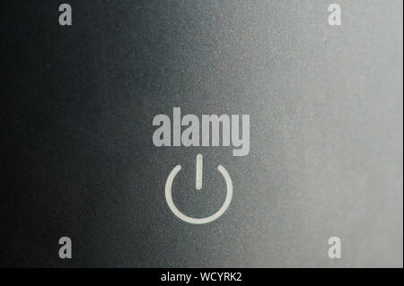 Power button on grey metal background macro close up view Stock Photo