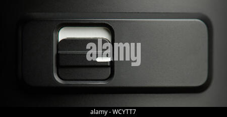On and off dark gray metal switch macro close up view Stock Photo