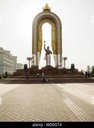 The Ismail Somoni Monument towers over Dusti Square in Dushanbe, Tajikistan, its gilded arch framing the bronze statue, two stone lions flanking the pedestal. Stock Photo