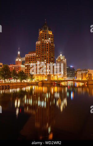 Downtown Milwaukee reflected in the Milwaukee River at night, Milwaukee, Wisconsin Stock Photo