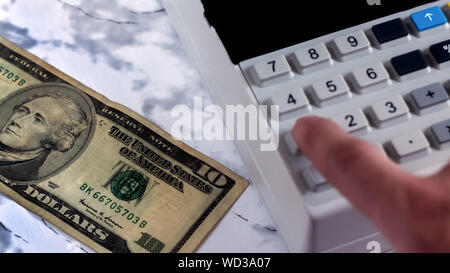 Cashier counts the money in the Bank. Accountant beats check after payment of money.Counting money on a calculator.An office worker counts the money i Stock Photo