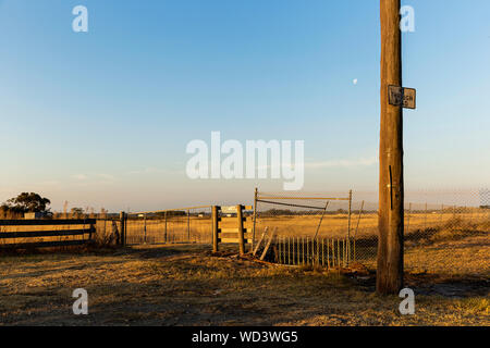 Country wooden boarder fence at the end of a dead end road. Stock Photo