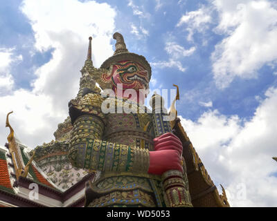 low angle shot of a giant red demon statue at wat phra kaew in bangkok Stock Photo