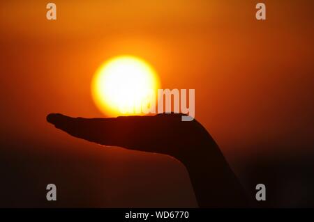 Optical Illusion Of Hand Holding Sun
