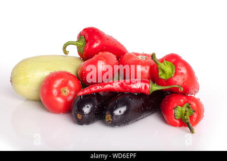 Tomatoes, red sweet peppers, red hot chili peppers, eggplants, green zucchini in drops of water on white background close up isolated Stock Photo