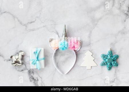 Set of various white, pink and blue Christmas decorations: gifts and toys on marble background. Top view, flat lay. Stock Photo