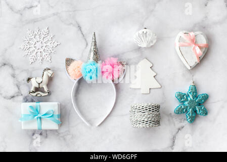 Set of various white, pink and blue Christmas decorations: gifts and toys on marble background. Top view, flat lay. Stock Photo