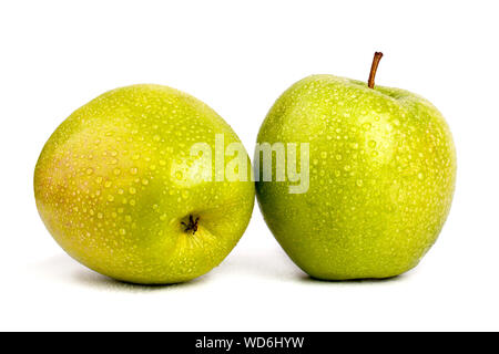 Two juicy green apples in drops of water on white background isolated close up macro Stock Photo