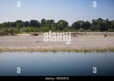 Natural summer river landscape with blue water, trees and sandy beach. Bernate Ticino, Lombardia, Italy. Stock Photo