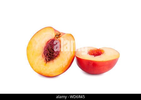 Peach sliced into two halves with stone on white background isolated close up Stock Photo