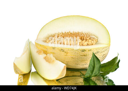 Sliced melon with seeds, two melon slices and green leaves on white mirror background with reflection with water drops isolated close Stock Photo