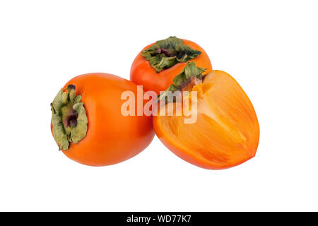 Two orange persimmons fruits or diospyros and one cut off half of persimmon with green leaves on white background isolated close up Stock Photo