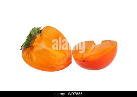 Persimmon fruit or diospyros kaki with green leaves sliced in two halves on white background isolated close up Stock Photo