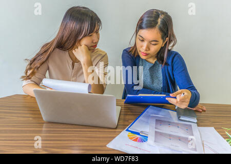Young business people discussing and analyzing financial statistics documents Stock Photo