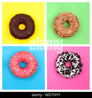 Donuts on a bright multi-colored background top view close up Stock Photo