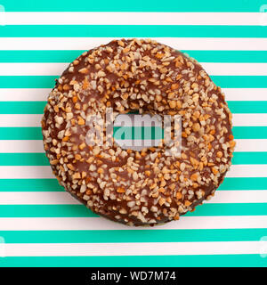 Donut with nuts on a background in strips white and green top view in a square Stock Photo