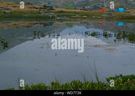 Tentes reflects on a quite mountain lake of french alps at dawn Stock Photo