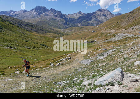 SAINT-SORLIN, FRANCE, August 9, 2019 : Hiker on the path to the famous pass named Col de La Croix de Fer in French Alps. Stock Photo