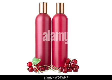 Two red plastic shampoo and hair conditioner bottles, shower gel and moisturizing lotion template, white background isolated closeup, decorative grape Stock Photo