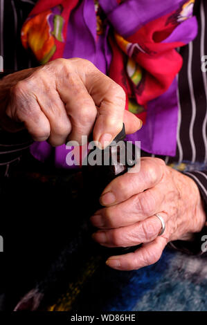 Elderly women opening medication bottle Stock Photo