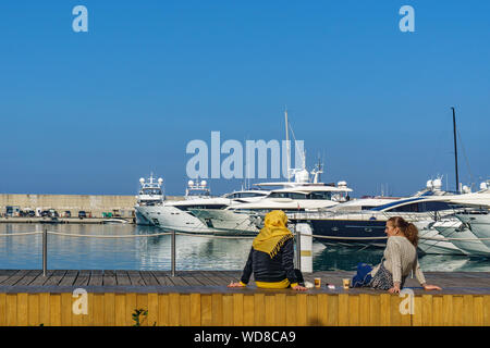 two lebanese woman sitting in the zaitunay bay the marina of beirut lebanon 2 february 2018 Stock Photo