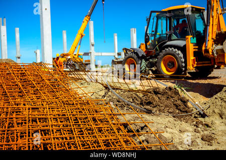 View on rusty square reinforcement for concrete, construction site is in background. Stock Photo