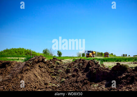 Dump trucks are in transport on building site, passing over. Stock Photo