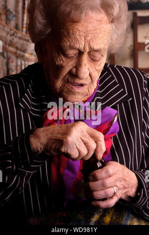 Portrait of an senior citizen female opening her medication bottle. Stock Photo