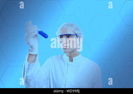 chemist examines a sample in a reagent glass Stock Photo