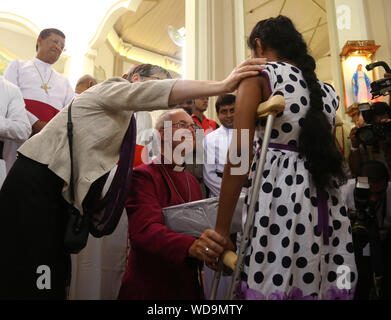 Negombo, Sri lanka. 29th Aug, 2019. The Archbishop of Canterbury Justin Welby blesses a survivor of the Easter Sunday attack at St. Sebastian's church in Katuwapitiya village, Negombo, Sri Lanka, August. 29, 2019. Credit: Pradeep Dambarage/ZUMA Wire/Alamy Live News Stock Photo