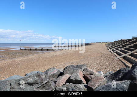 Heacham north on a sunny day with blue clear skies. Shoreline and beach in view. Stock Photo