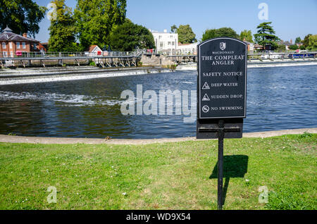 A warning sign near the Marlow weir on The River Thames warns people of deep water and instructs that there should be no swimming. Stock Photo
