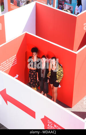 (left to right) Pearl Mackie, Holliday Grainger and Charlie Webster at the ActionAid UK 'Maze of Injustice' in Marble Arch, London. The maze aims to engage the public in their campaign calling for better justice for women and girls who have survived violence. Stock Photo