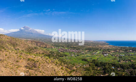 Aerial panorama of Mt Agung volcano and the coastline in north Bali, near Amed, in Indonesia, Southeast Asia Stock Photo