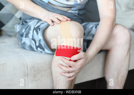 Man sitting on comfy couch Stock Photo